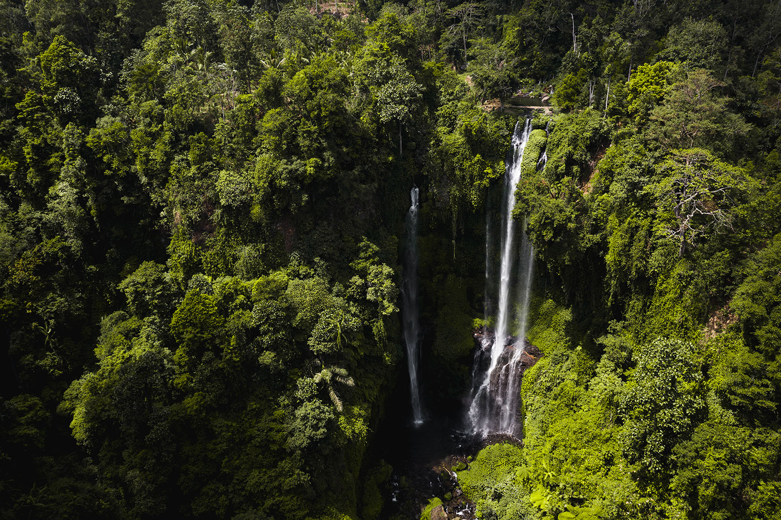 steile mit Pflanzen bewachsene Klippe mit Wasserfall